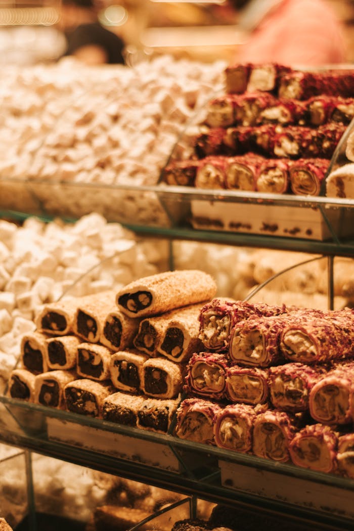 Service A close-up of assorted Turkish delights arranged on shelves in a store.
